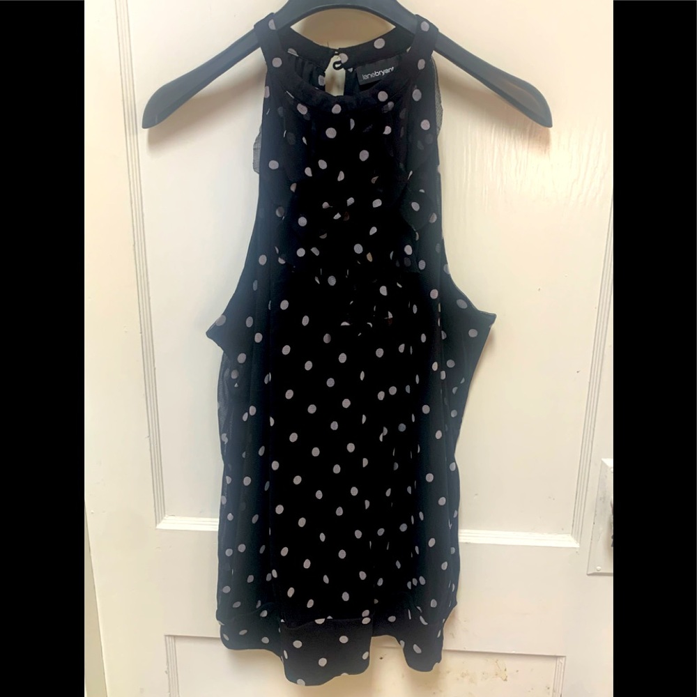 HIGH-NECKED, POLKA DOT, BANDED BOTTOM CAMISOLE WIYH A RUFFLED DECORATION.